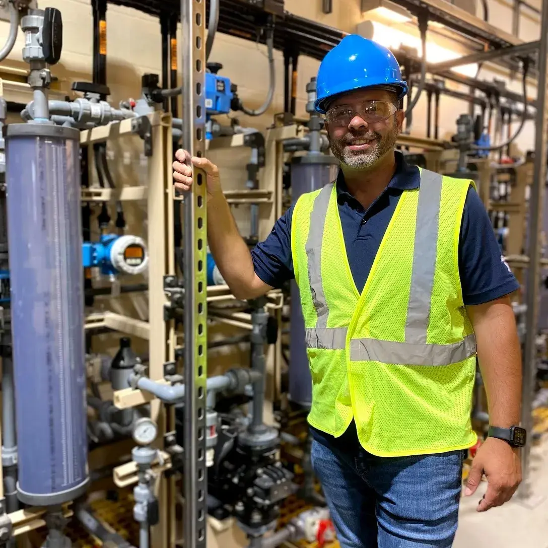 Geiger sales engineer in front of a metering system at a wastewater treatment plant